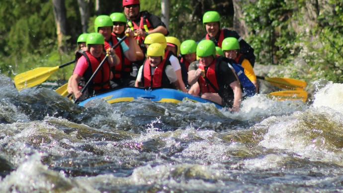 people in green life vest on water during daytime